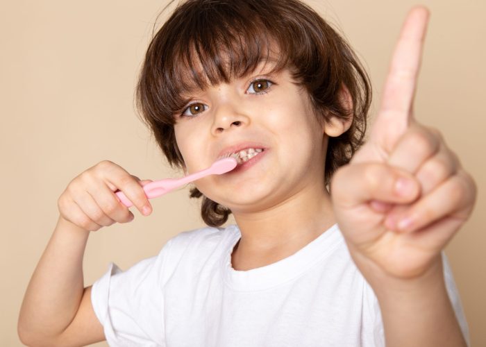 cute-boy-adorable-cleaning-his-teeth-pink